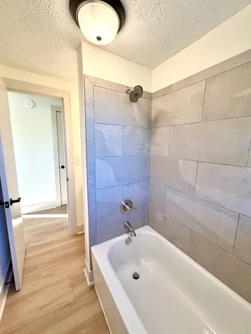 a bathroom with a tub and a shower