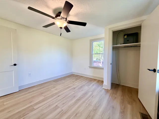 a view of empty room with wooden floor