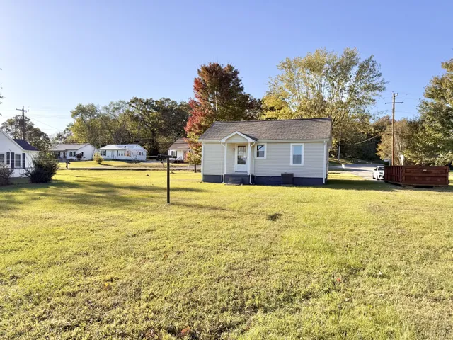 a view of a house with a yard and swimming pool