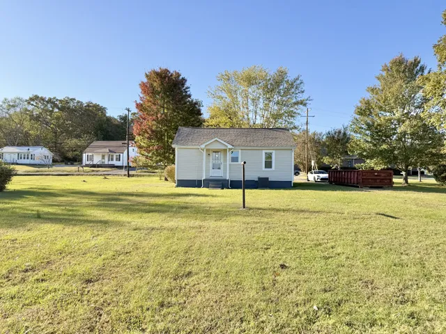 a swimming pool with outdoor seating and yard