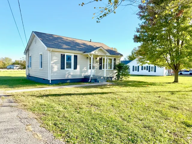 a front view of house with yard space and swimming pool