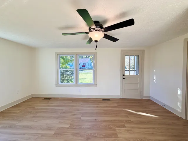 wooden floor in an empty room with a window