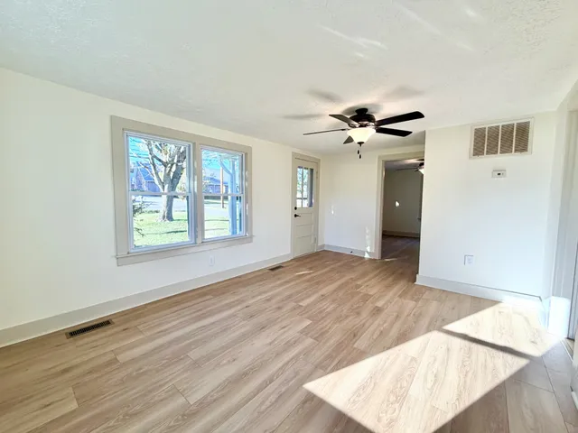 wooden floor in an empty room with a window