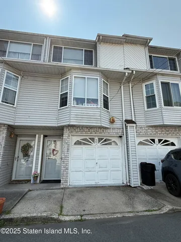 a view of a white house with large windows