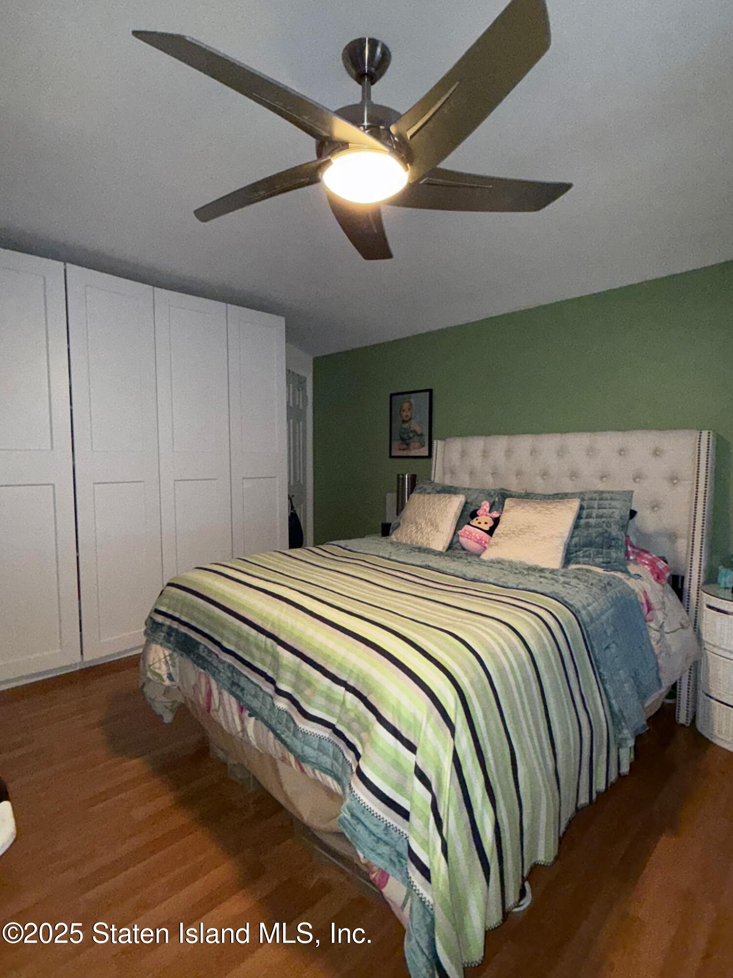 37 Linda Lane Staten Island, NY 10312 - Photo 13 of 20 a bedroom with a bed and a chandelier