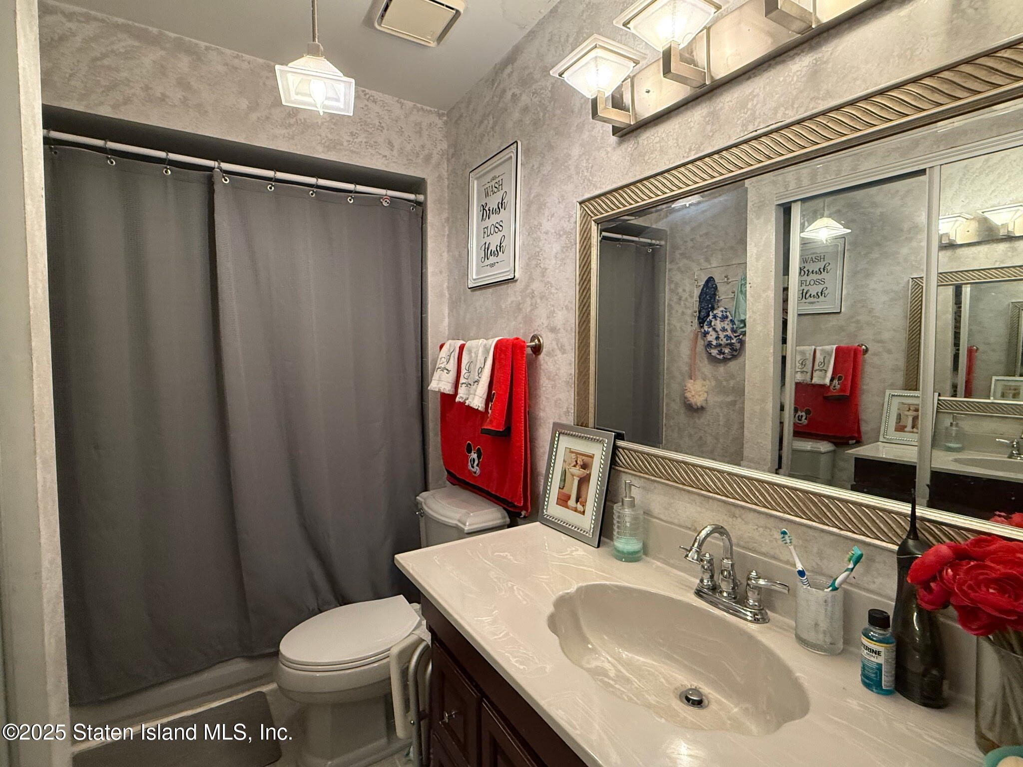 37 Linda Lane Staten Island, NY 10312 - Photo 15 of 20 a bathroom with a sink vanity mirror and toilet