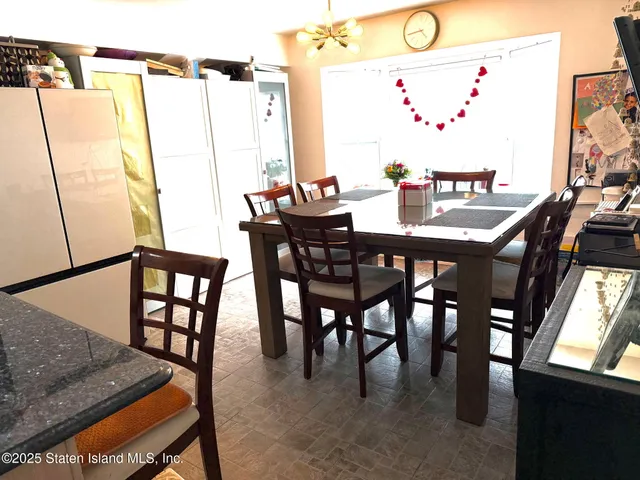 a view of a dining room with furniture and a window