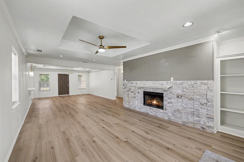 307 Dixon Street Terrell, TX 75160 - Photo 6 of 32 Spacious living area featuring wood-finish flooring, a tray ceiling with a ceiling fan, and recessed lighting