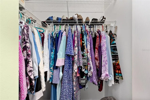 a view of walk in closet with clothes