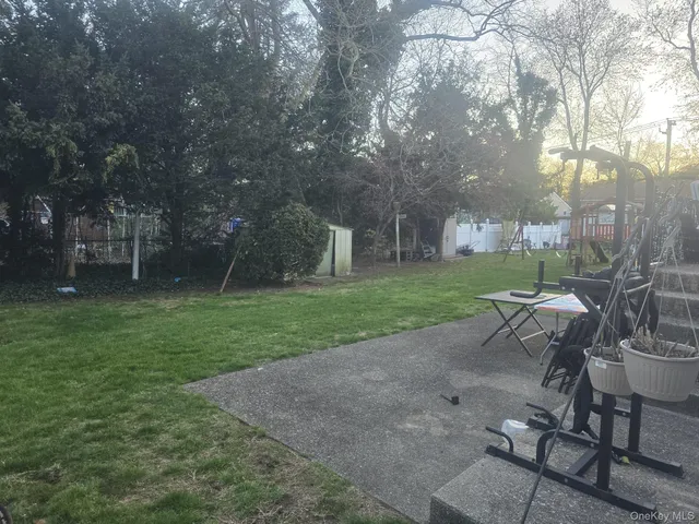 a view of backyard with seating area and green space