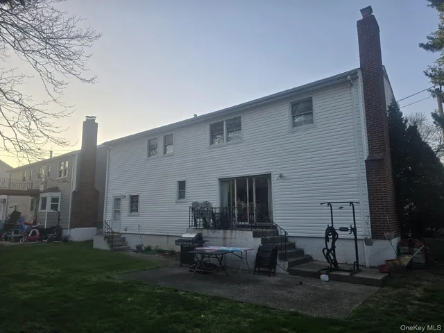a backyard of a house with table and chairs
