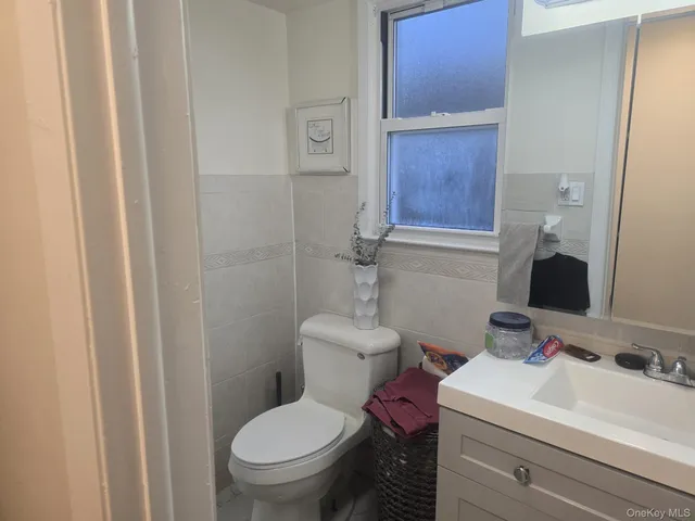 a bathroom with a sink toilet and mirror