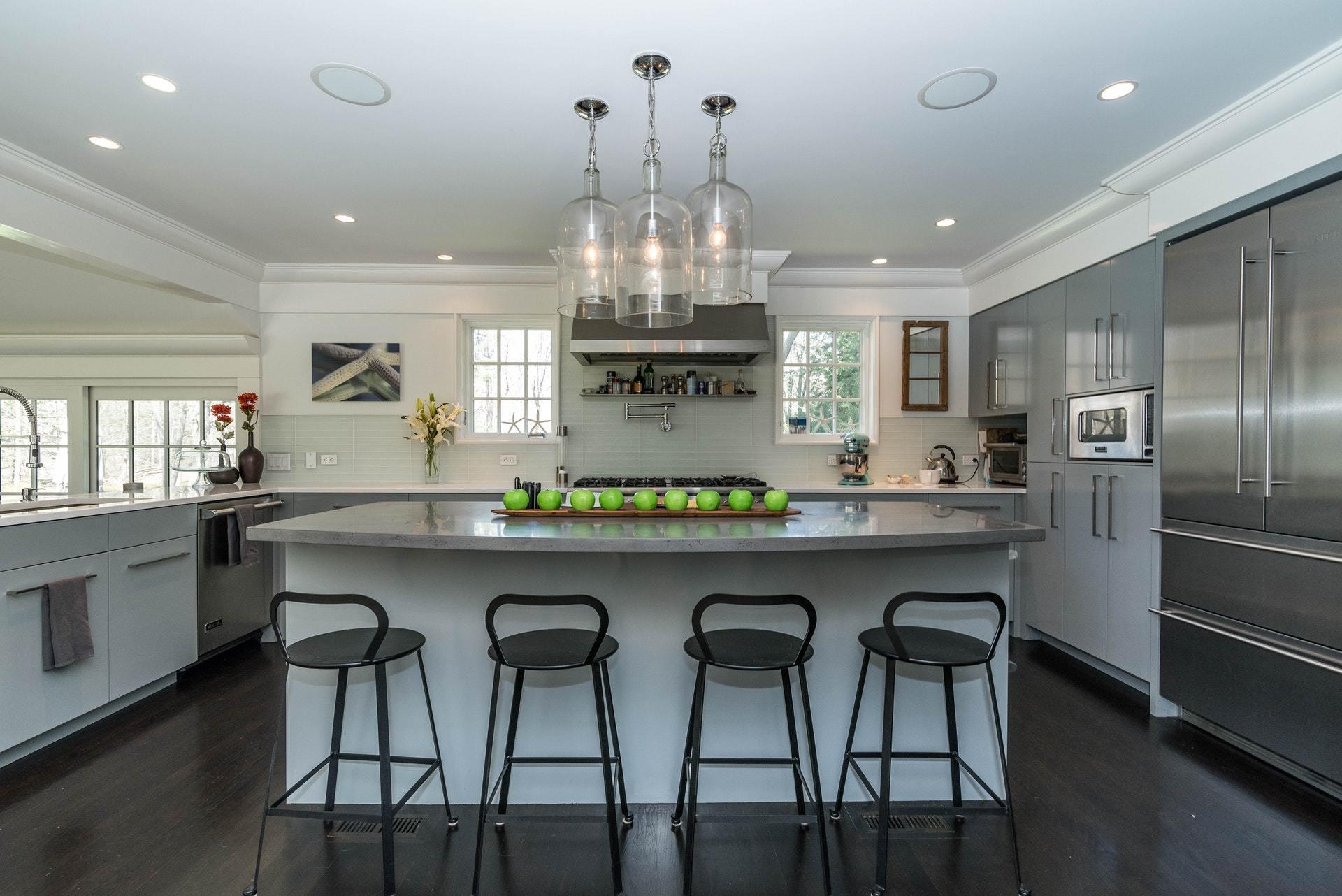 947 Valley Road New Canaan, CT 06840 - Photo 12 of 32 a kitchen with stainless steel appliances granite countertop a dining table chairs stove and refrigerator