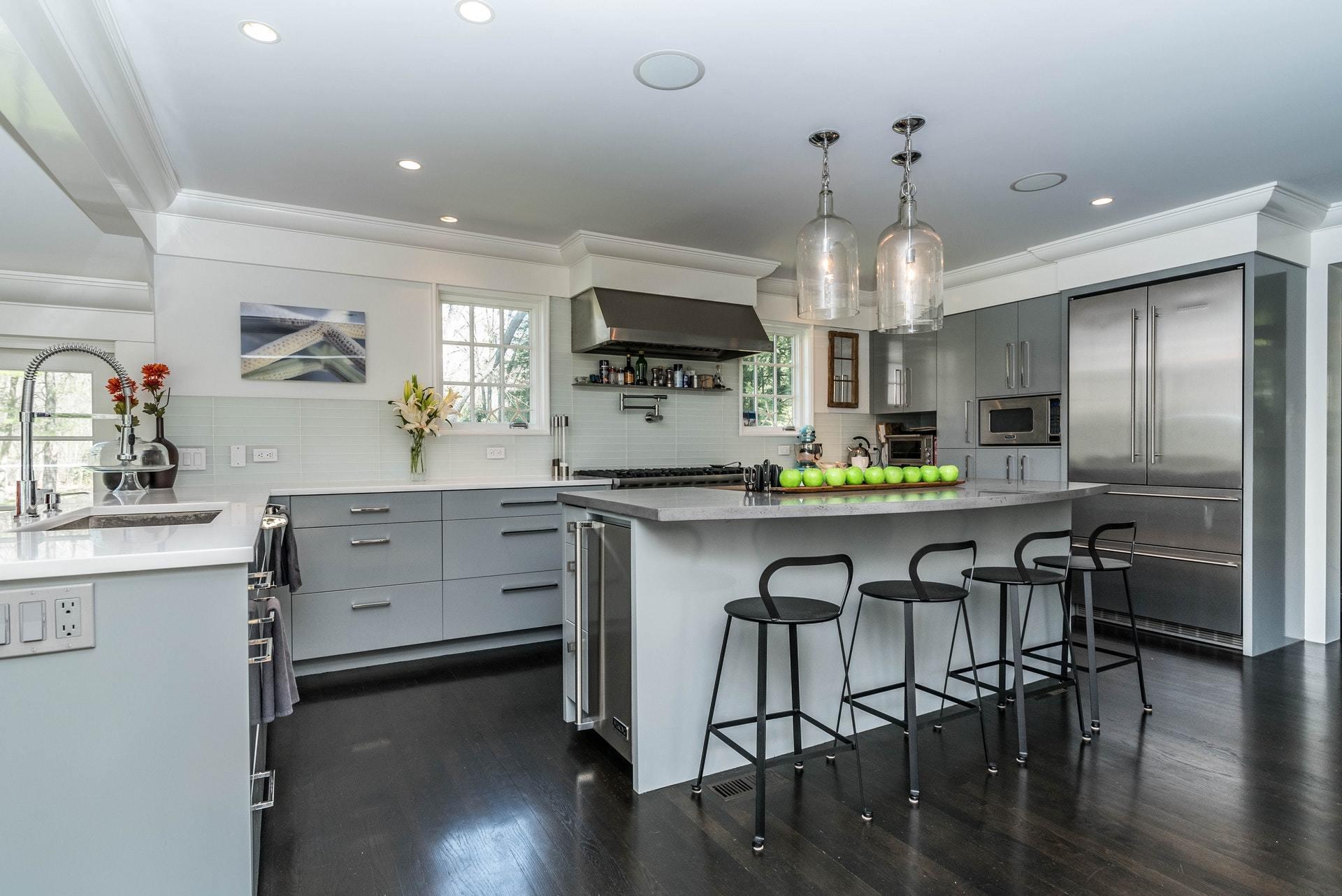 947 Valley Road New Canaan, CT 06840 - Photo 13 of 32 a kitchen with stainless steel appliances a table chairs refrigerator and sink