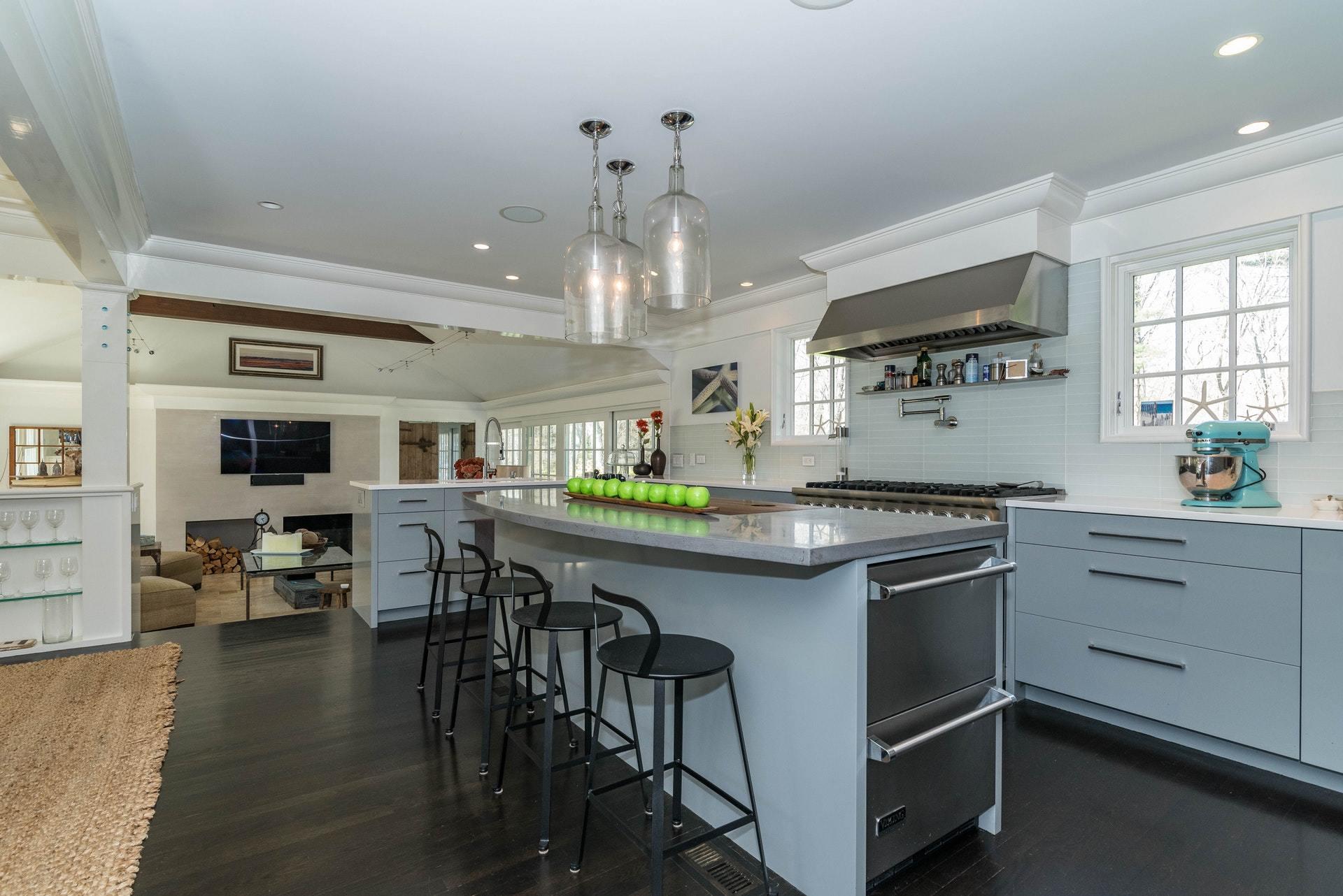 947 Valley Road New Canaan, CT 06840 - Photo 14 of 32 a kitchen with a table chairs stove and cabinets