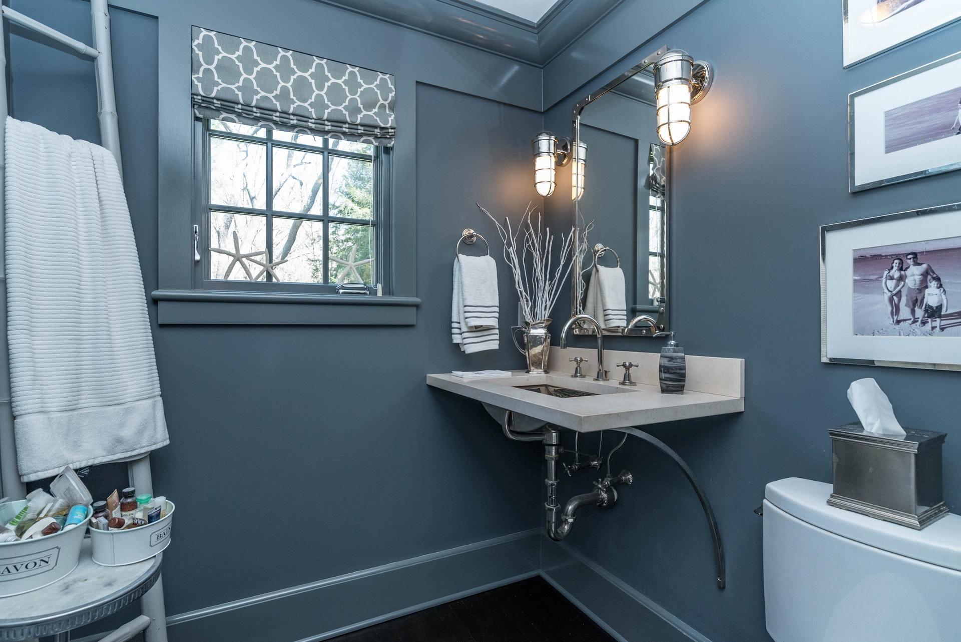 947 Valley Road New Canaan, CT 06840 - Photo 19 of 32 a bathroom with a sink a toilet and a mirror