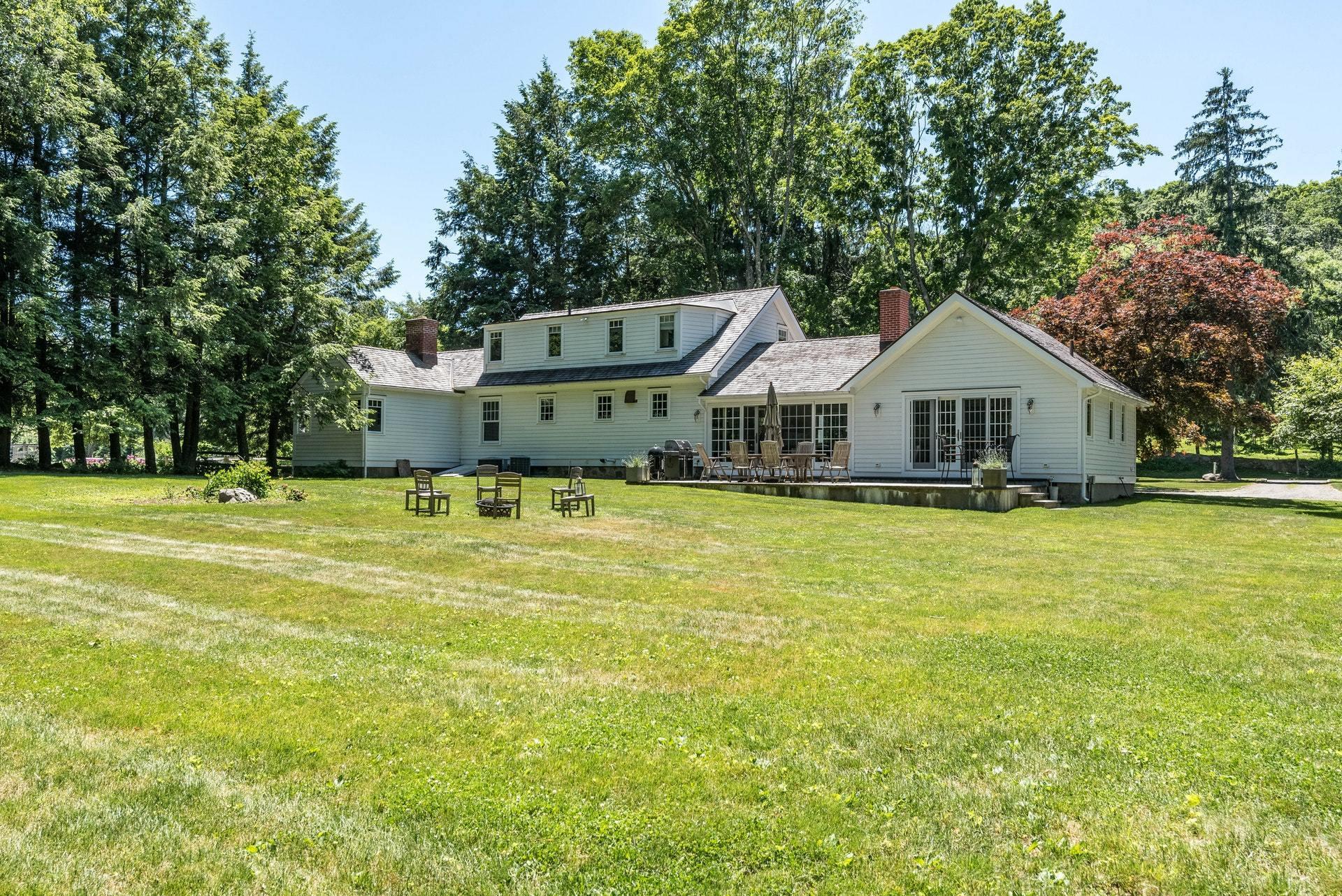 947 Valley Road New Canaan, CT 06840 - Photo 28 of 32 a front view of a house with swimming pool