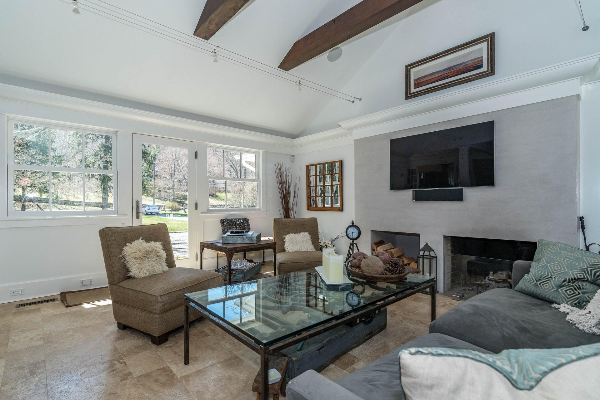 947 Valley Road New Canaan, CT 06840 - Photo 6 of 32 a living room with furniture fireplace and a flat screen tv
