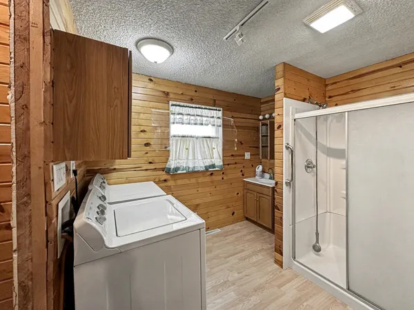 a bathroom with a toilet sink a mirror and shower
