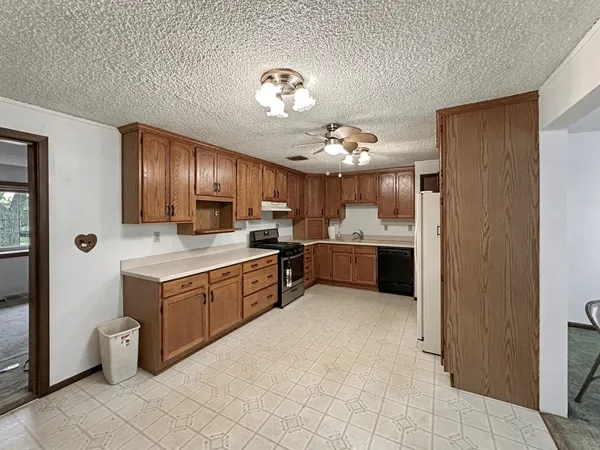 a large kitchen with cabinets and stainless steel appliances