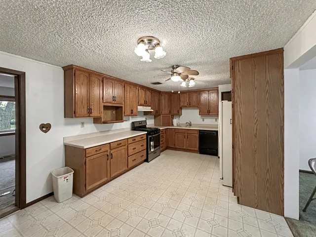a large kitchen with cabinets and stainless steel appliances