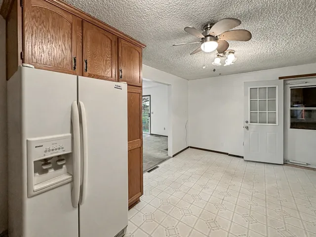 a view of a livingroom with a cabinet and a refrigerator
