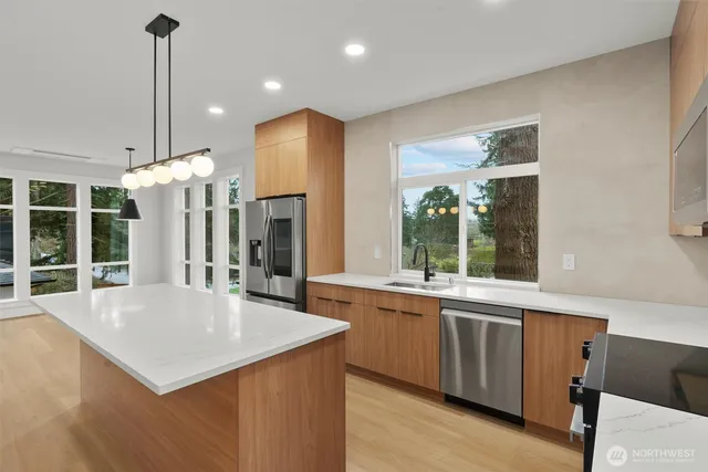 a kitchen with a stove a refrigerator and a sink