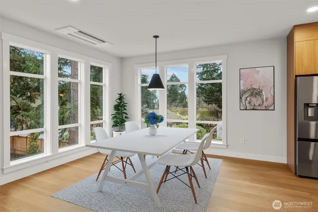 a view of a dining room with furniture window and wooden floor