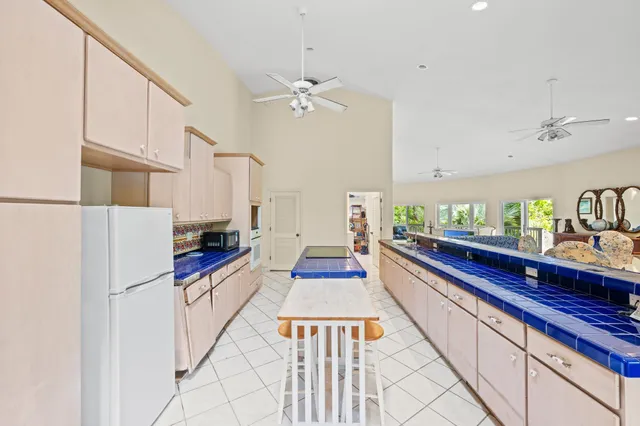 a kitchen with stainless steel appliances a refrigerator sink and cabinets