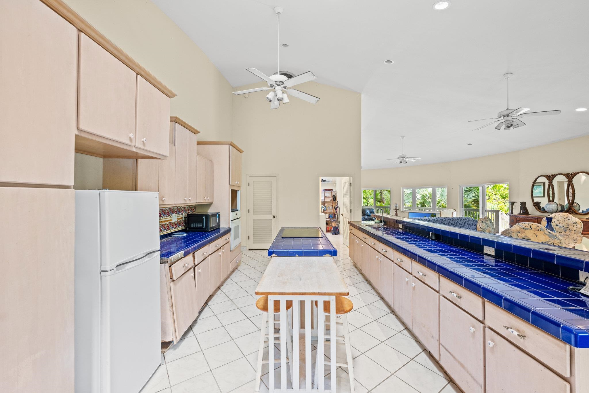 155 Uwala Road Hana, HI 96713 - Photo 11 of 41 a kitchen with stainless steel appliances a refrigerator sink and cabinets