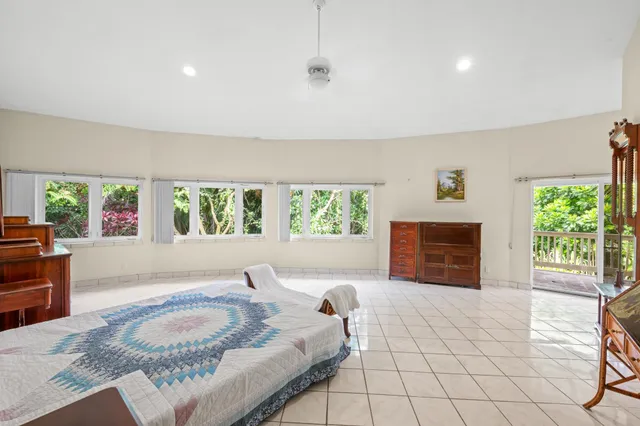 a spacious bedroom with a bed and a couch