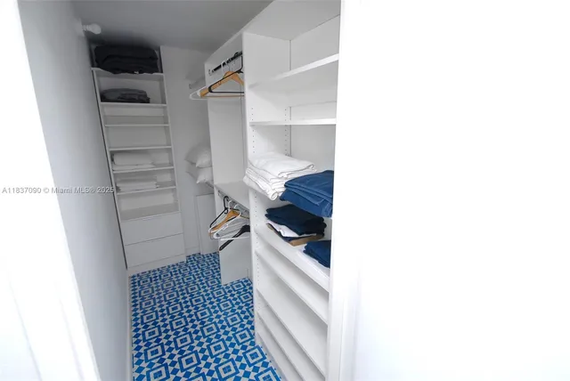 a kitchen with a refrigerator and cabinets