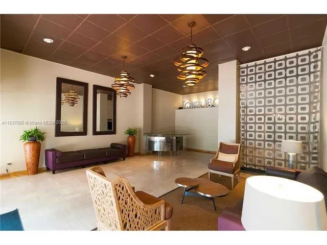 a view of a kitchen with granite countertop a couch and a view of living room