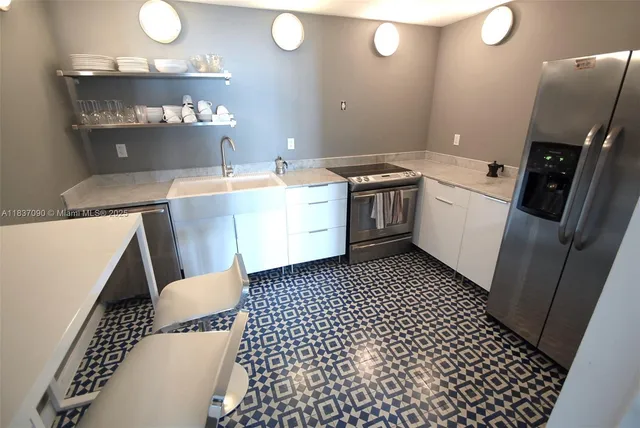 a kitchen with a sink toilet and cabinets