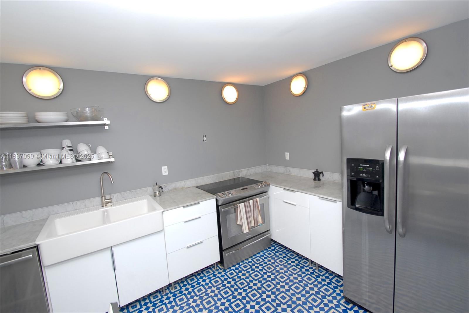 1800 Collins Avenue, Unit 18F Miami Beach, FL 33139 - Photo 4 of 22 a kitchen with a sink stainless steel appliances and cabinets
