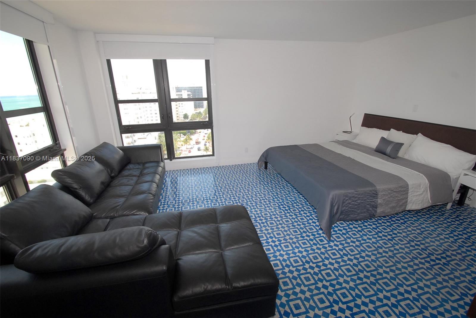 1800 Collins Avenue, Unit 18F Miami Beach, FL 33139 - Photo 9 of 22 a bed room with a bed and a couch