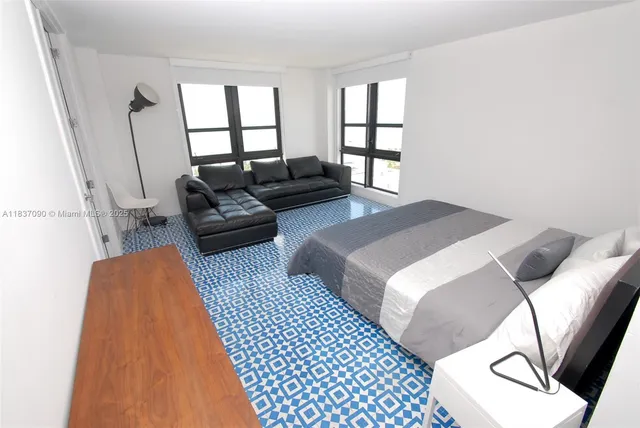 a bedroom with a bed and a couch