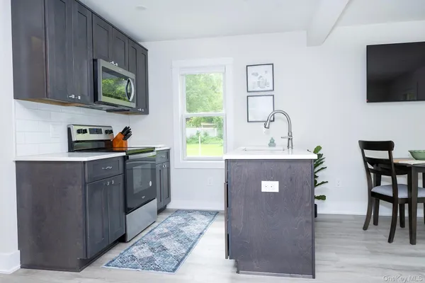 a kitchen with stainless steel appliances granite countertop wooden cabinets a sink and a stove