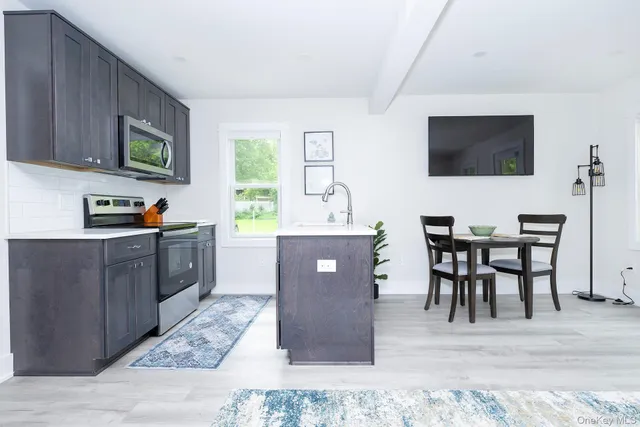 a dining room with a wooden table and chairs