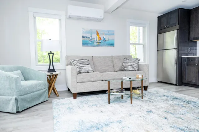 a living room with furniture a refrigerator and a couch