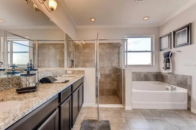 a bathroom with a granite countertop sink a mirror and a bathtub