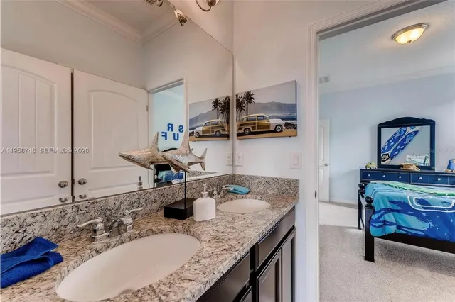 a bathroom with a granite countertop sink a mirror and cabinets