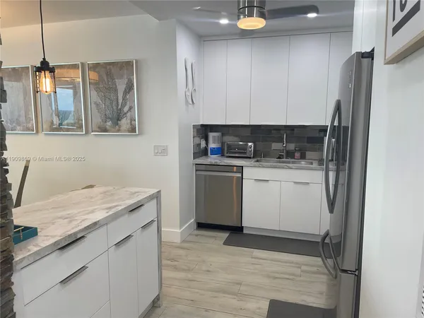 a kitchen with a sink stove and refrigerator