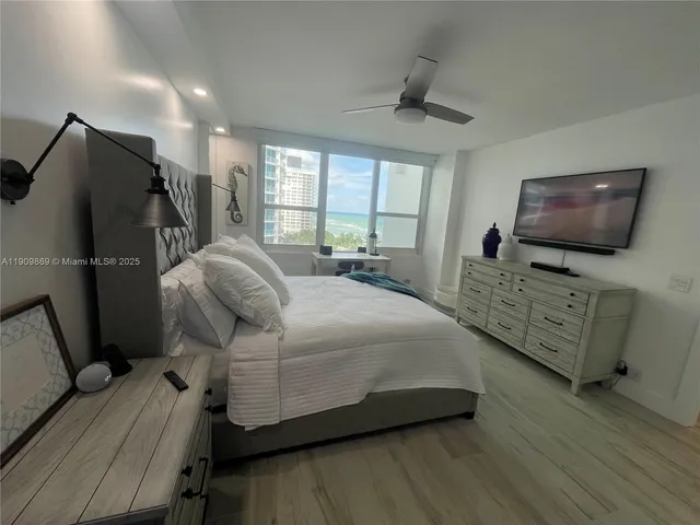 a bedroom with a bed and flat screen tv