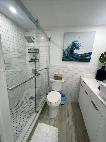 a bathroom with a toilet and a shower