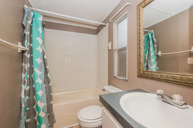 a bathroom with a sink a mirror and a toilet