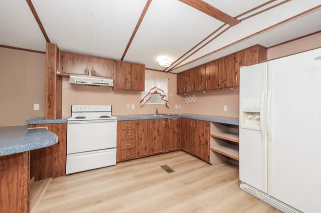 a kitchen with sink cabinets and appliances