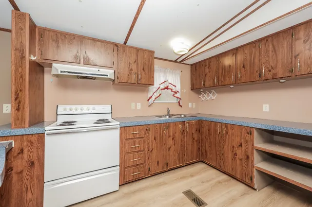 a view of a kitchen with wooden floor