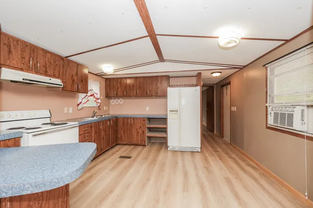a kitchen with wooden cabinets and a stove top oven