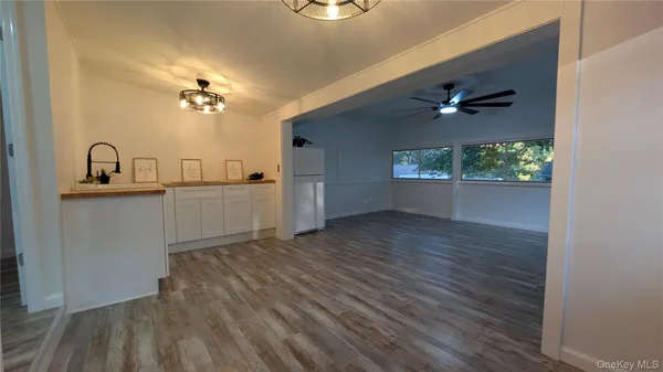 a kitchen with a sink and chandelier